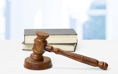 Wooden gavel and books on wooden table