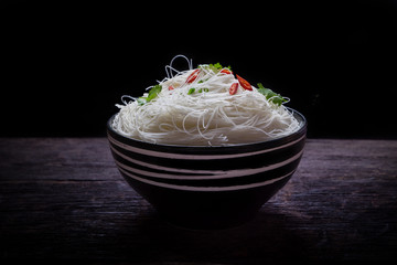 Instant vermicelli in the bowl on wooden background
