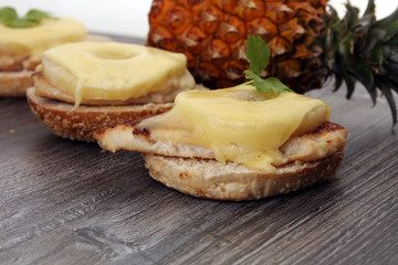 toast hawaii, , cheese and pineapple on wooden background with chicken breast