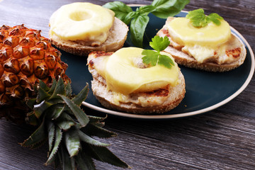 toast hawaii, , cheese and pineapple on wooden background with chicken breast