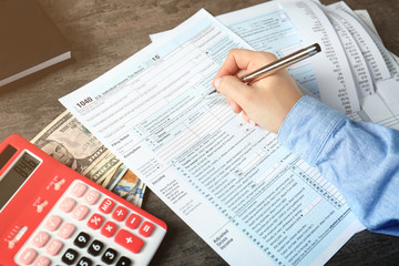 Naklejka premium Woman working with calculator and documents. Tax concept