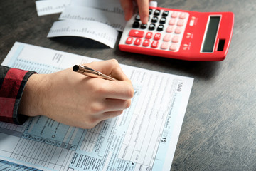 Man working with calculator and documents. Tax concept
