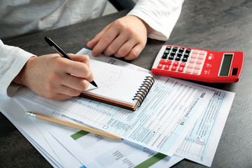 Man working with calculator and documents. Tax concept