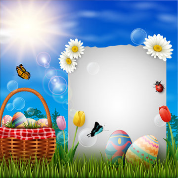 Happy easter eggs with paper and basket on grass background