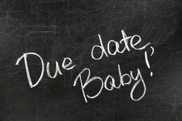 Obraz premium Words DUE DATE, BABY written with chalk on blackboard