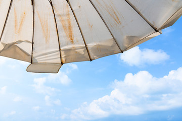White Umbrella of Baan Sattahip Resort and sea background at Sattahip, Chon Buri, Thailand.