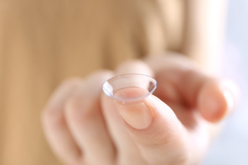 Contact lens on finger, closeup