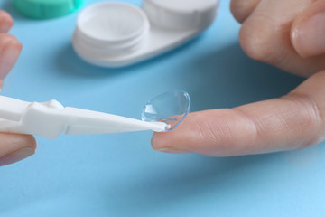 Female hands with contact lens, closeup