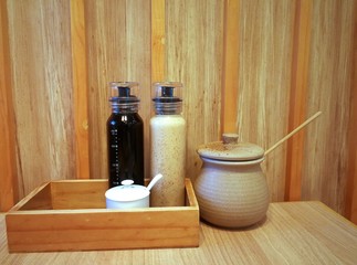 Bottles and jar of Japanese condiments on wooden background