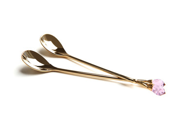 Two beautiful spoons on white background