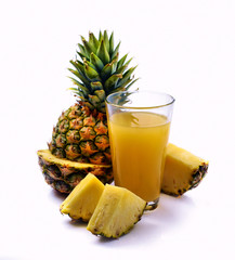  pineapple fruit and a glass of pineapple juice
