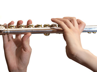 Metallic flute in female hands over white background