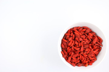dried goji berries in a small white bowl