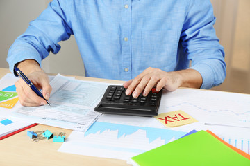 Man filling individual income tax return form, closeup