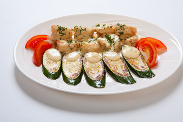 shrimps and grilled zucchini on a white plate