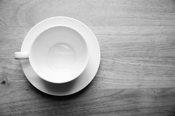 Top view  coffee mug  on wood table. black and white tone.