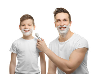 Father and son shaving on white background