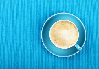 Fototapeta premium Full cappuccino latte coffee in blue cup top view