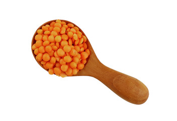 Orange lentil lens in wooden scoop on white