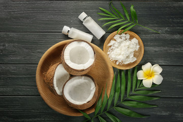 Composition with coconuts and oil on wooden background