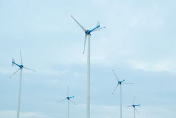 Wind turbines generating electricity with blue sky - energy conservation concept