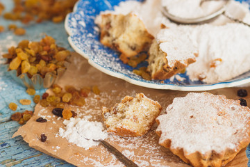 Fototapeta na wymiar Home-made baking: Cupcakes with raisins and sugar powder