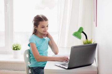 girl with laptop at home