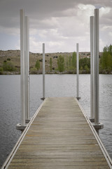 Quiet empty jetty on a lake on a peaceful overcast day
