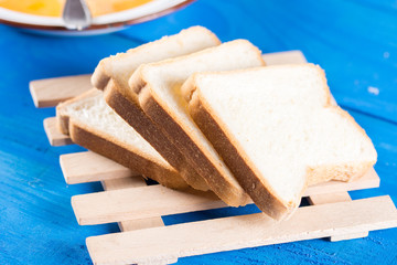 Slices of bread on the blue wooden background