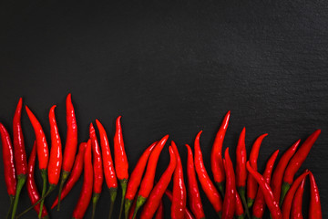 Thai red chili peppers on black slate plate