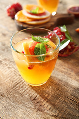 Glass of fresh citrus cocktail on table