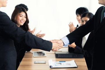 Asian businessman shaking hands in conference room. Business people shaking hands agreement concept.