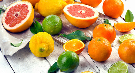 Fresh citrus fruits on wooden table
