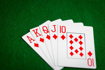 poker hand of playing cards on green casino cloth