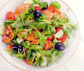 Fresh salad with chicken breast, arugula, cucumber  and tomato