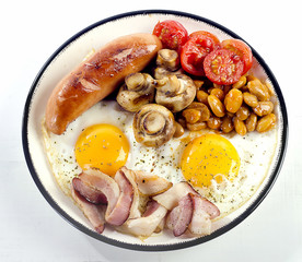 Full english breakfast. Fried egg, beans, tomatoes, mushrooms, bacon and sausage.