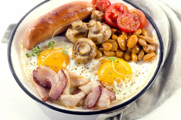 English breakfast fried egg, beans, tomatoes, mushrooms, bacon and sausage