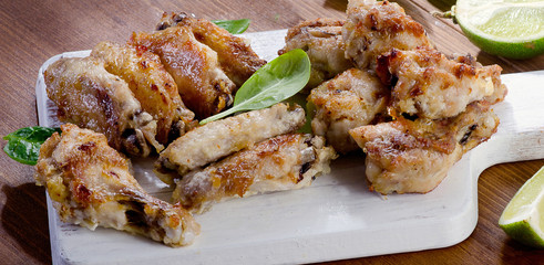 Chicken wings on a cutting board.