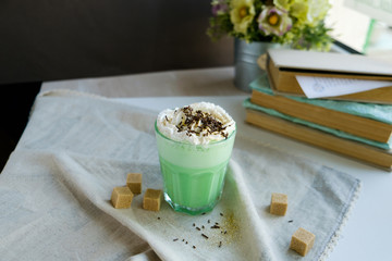 Green mint coffee with with cream and colorful decoration. Milk shake, cocktaill, frappuccino.  Unicorn coffee, unicorn food.