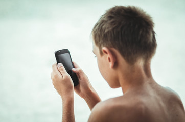 Teen plays in the phone