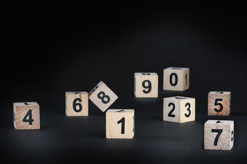 Business leader concept: wooden cubes number on black background,competition idea