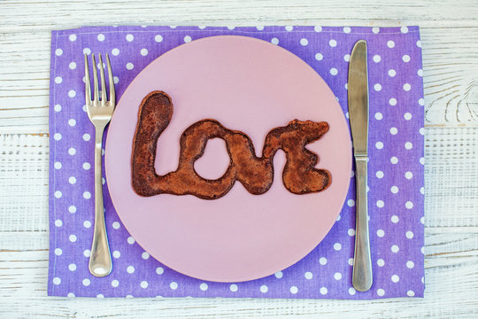 Chocolate pancake on a plate. The concept of food and love.