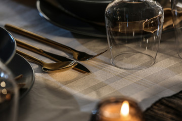 Empty glass and cutlery set on table in restaurant, closeup