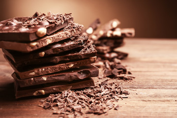 Pile of dark and milk chocolate on wooden table