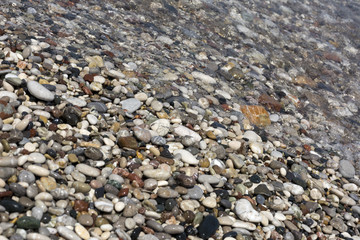 line of surf, wet pebbles, clear water