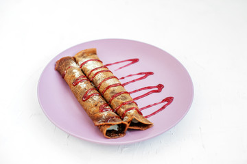 Chocolate Pancakes with cream and fruit jam. The concept of food, dessert and vegetarian.