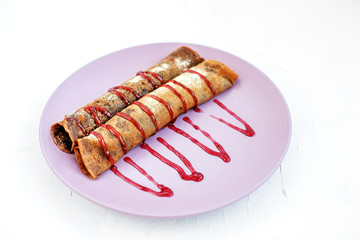 Chocolate pancakes with fruit jam. The concept of food, dessert and vegetarian.