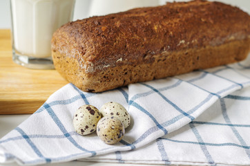 Homemade gluten free bread with linseed flour and psyllium husk. Glass of milk