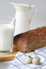 Homemade gluten free bread with linseed flour and psyllium husk. Glass of milk