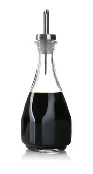 Bottle with tasty soy sauce on white background